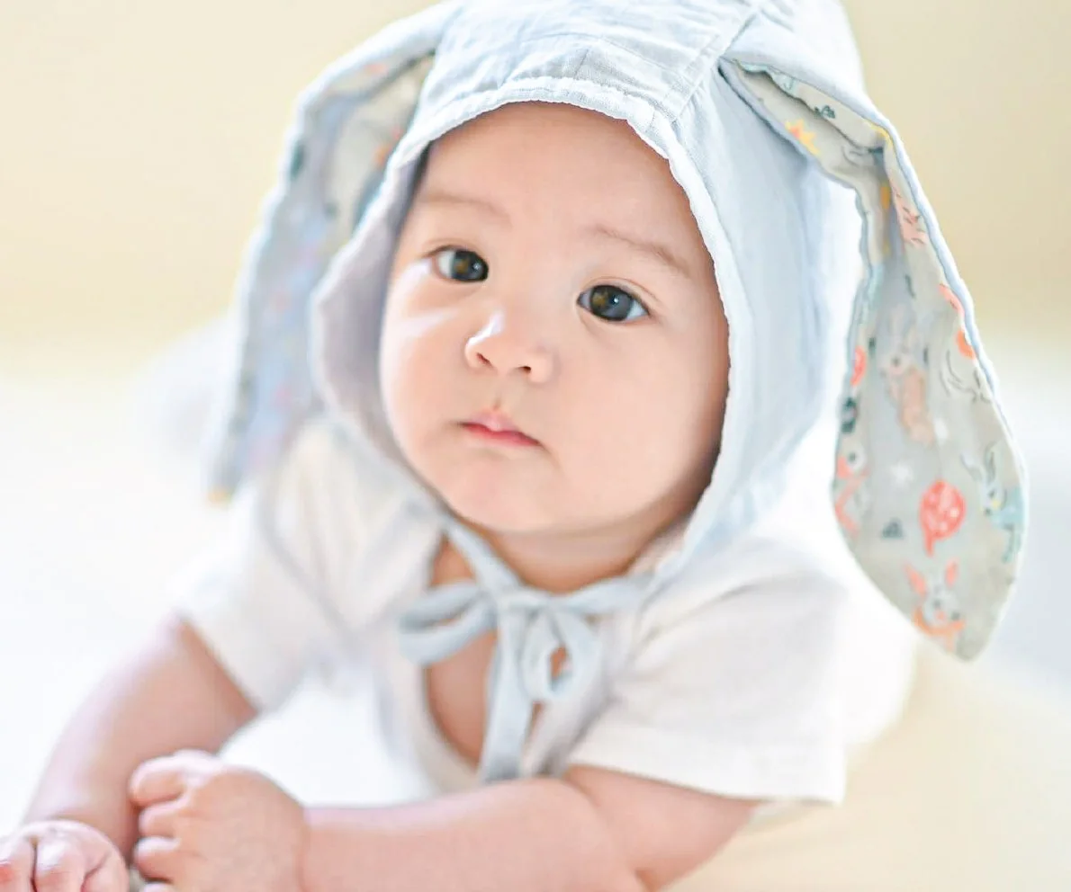 Baby in a Baby & Co. bunny-ear hood